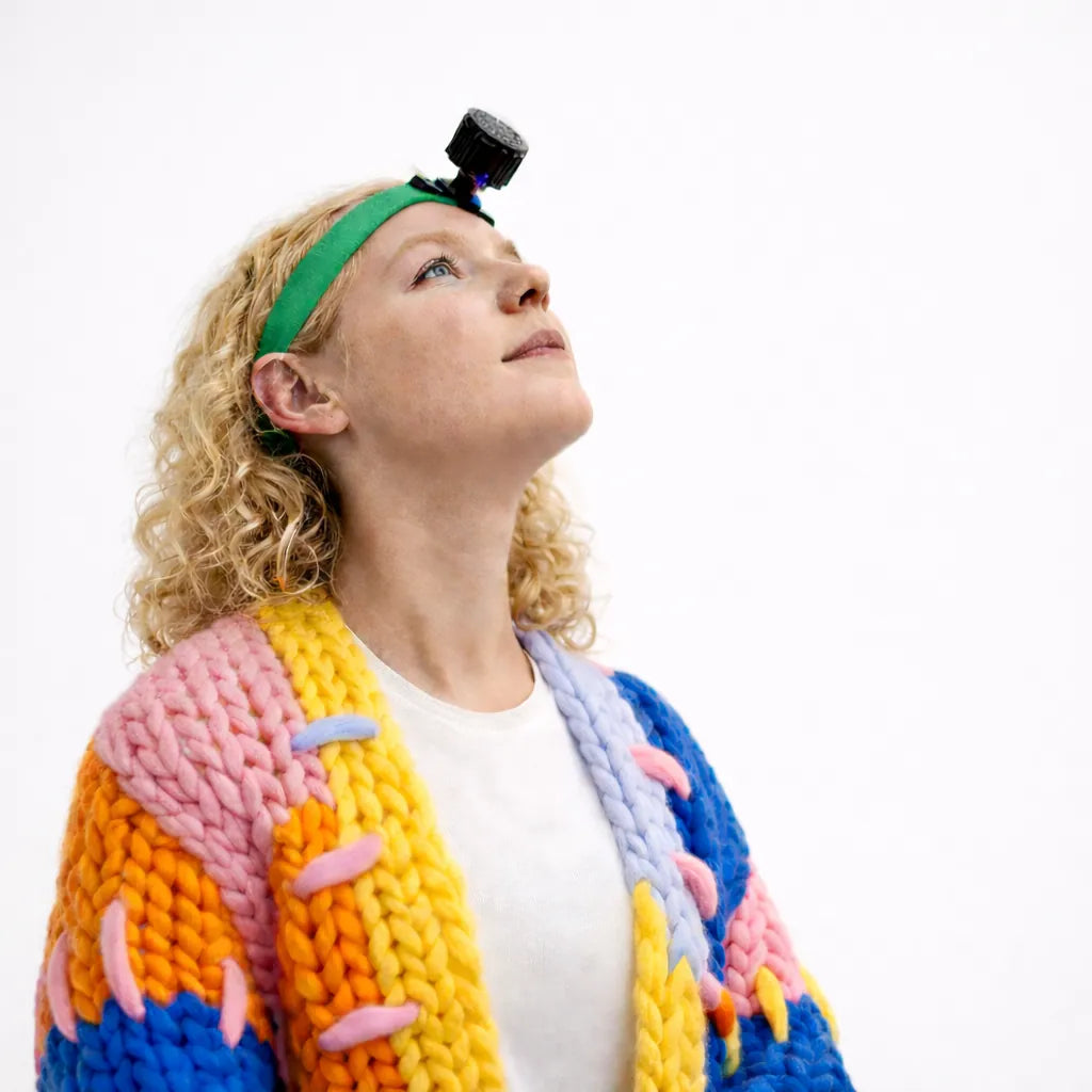 Woman wearing HeadX during active cervical range-of-motion testing.