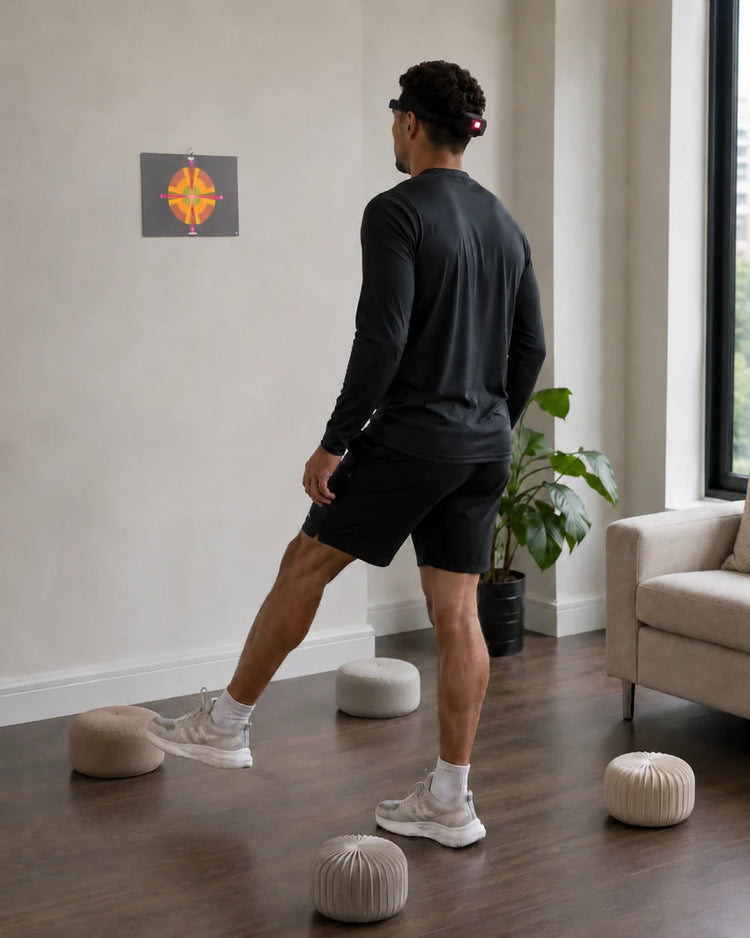 Person wearing HeadX Kross while stepping around obstacles and aiming at a wall target.